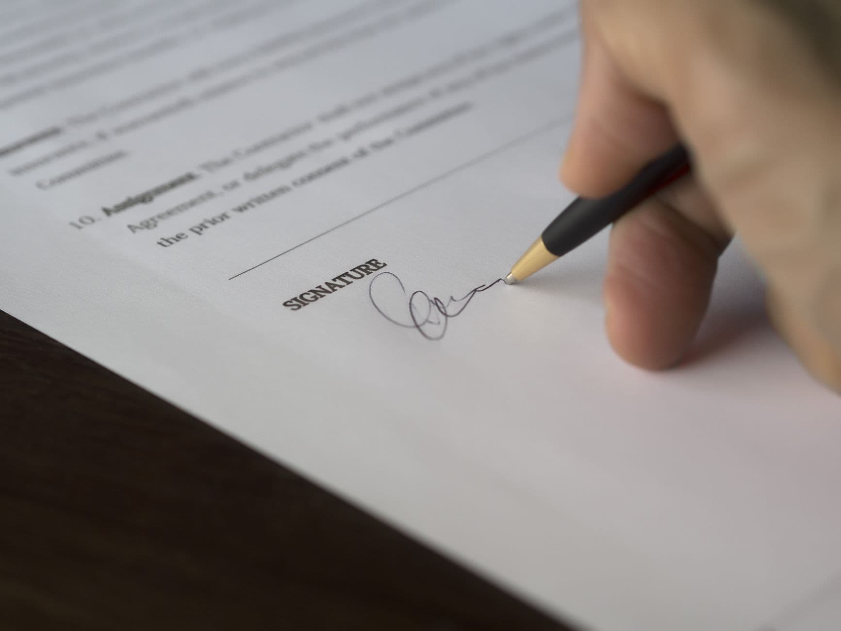 Building manager reviewing and marking up an elevator service contract at a desk