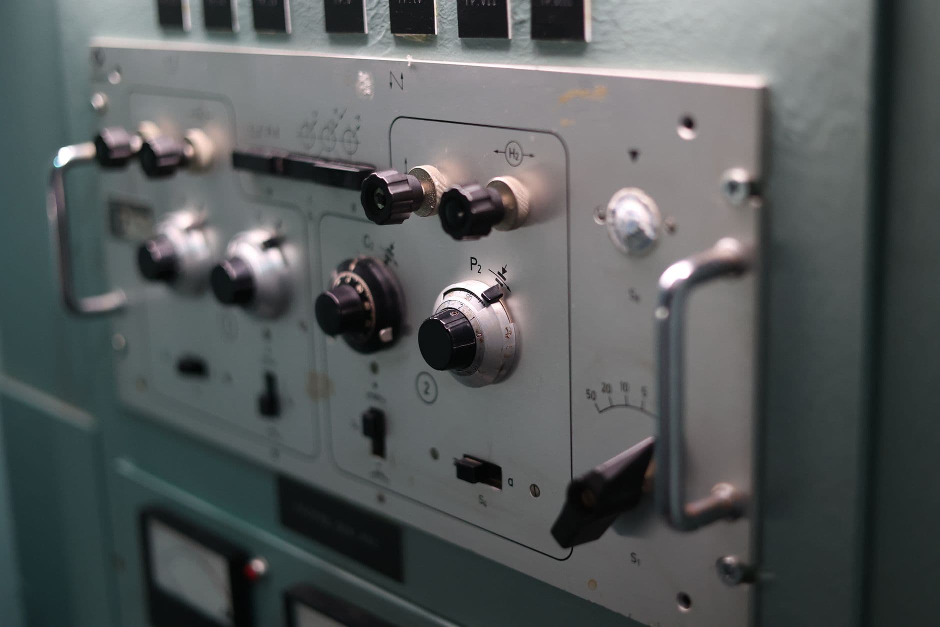 Technician inspecting an elevator controller panel in a machine room