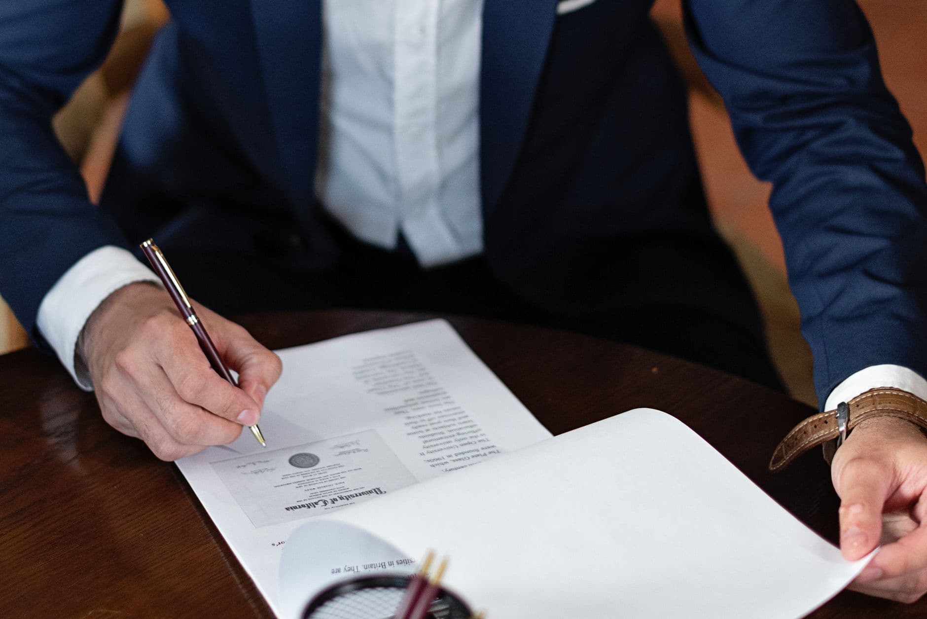 Close-up of a business contract on a desk with a pen, representing an elevator maintenance agreement under review