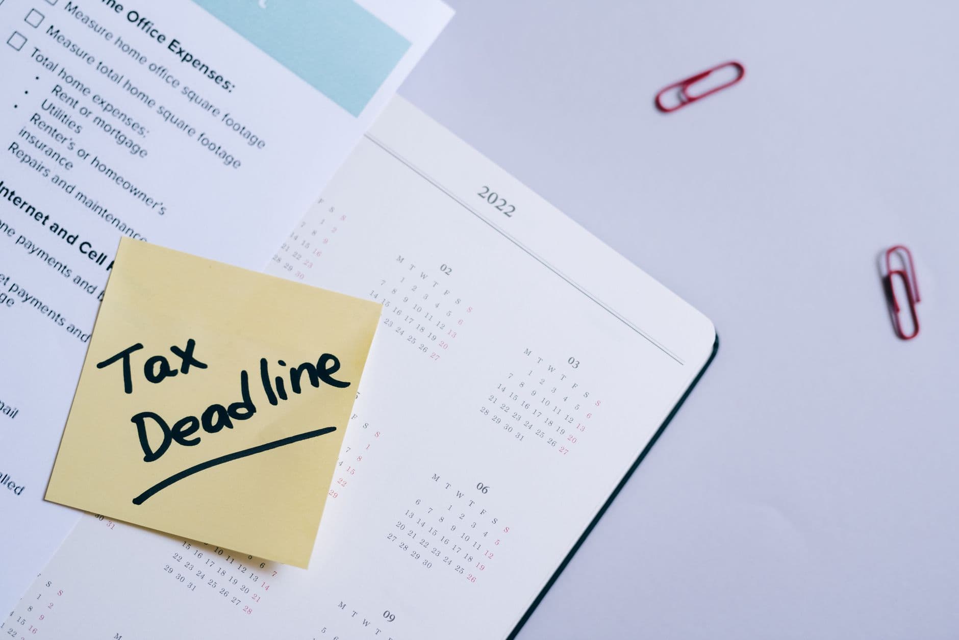 A desk calendar with a deadline circled next to a signed maintenance contract