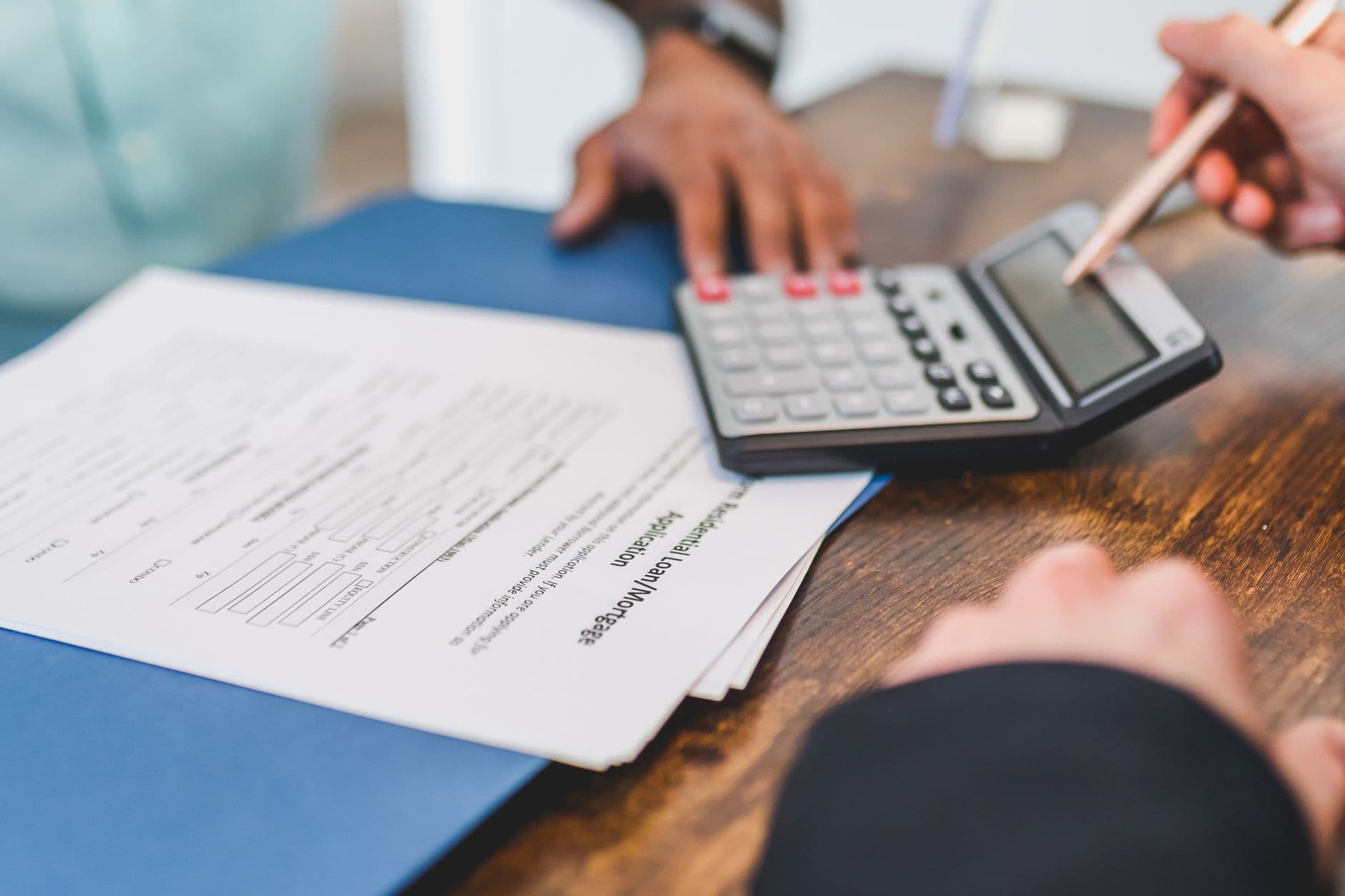 A maintenance contract with a calculator and pen on a desk, representing price escalation clause review