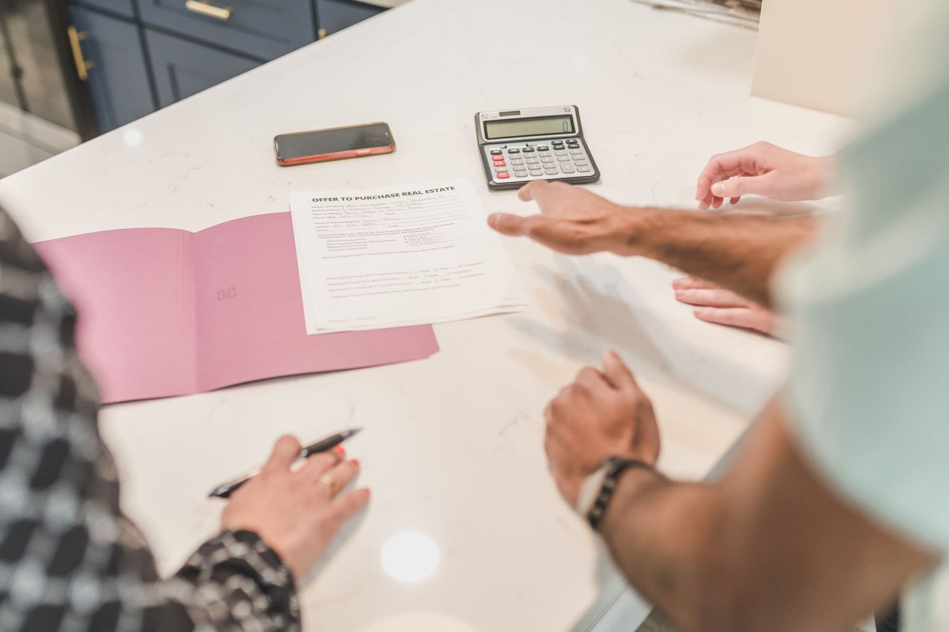 Property manager reviewing elevator maintenance proposals at a desk with a spreadsheet