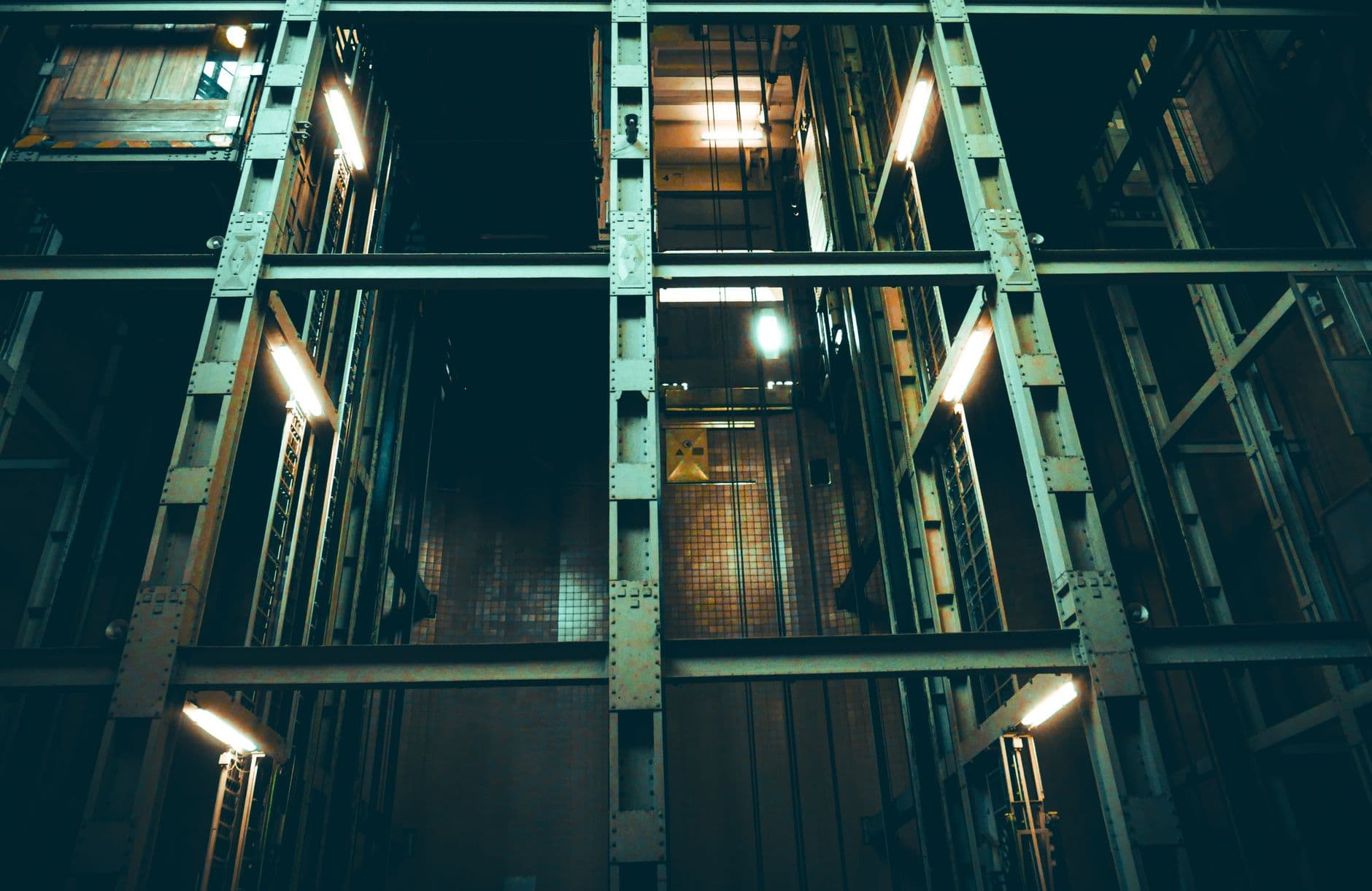 Technicians working inside an open elevator shaft during a modernization project