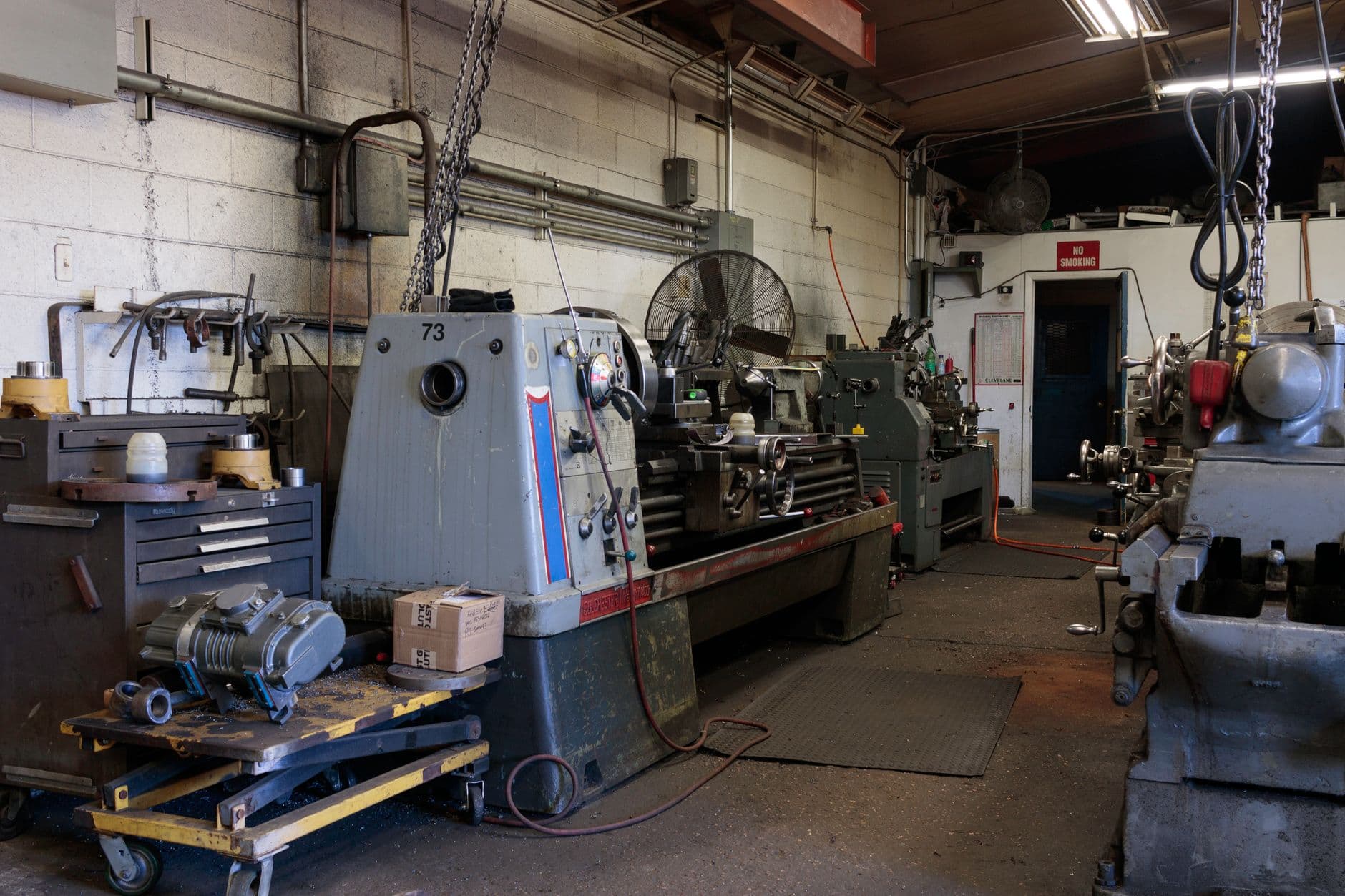 Elevator machine room showing controller and hoist equipment during a modernization assessment