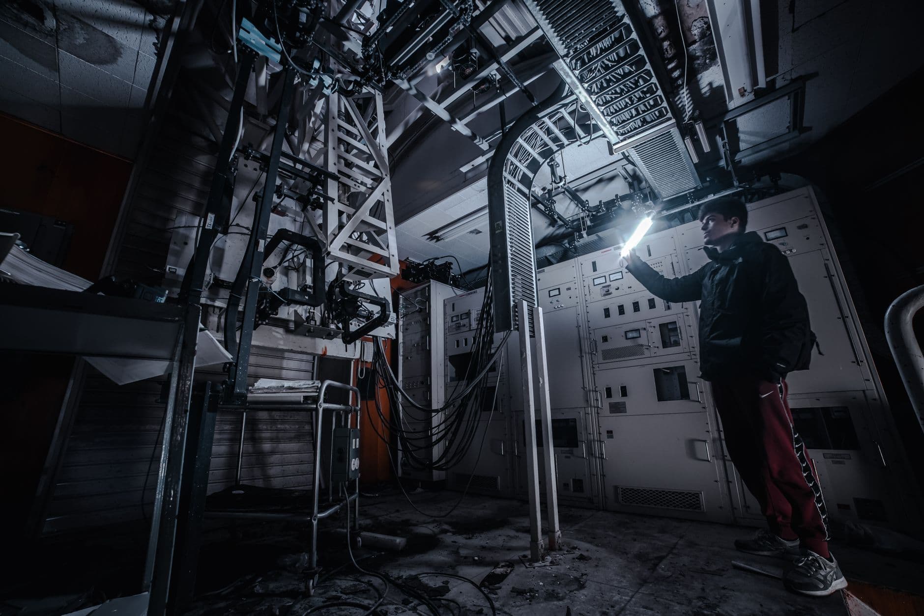 Elevator mechanic inspecting machine room equipment during a repair