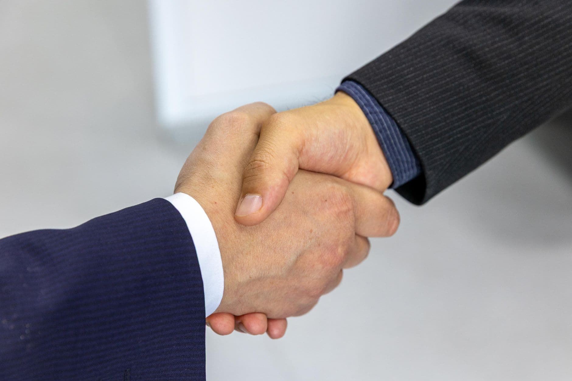 Two people reviewing and negotiating an elevator modernization contract at a desk
